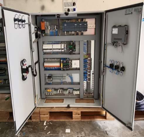 Open PLC control panel with I/O modules, relays and terminal wiring